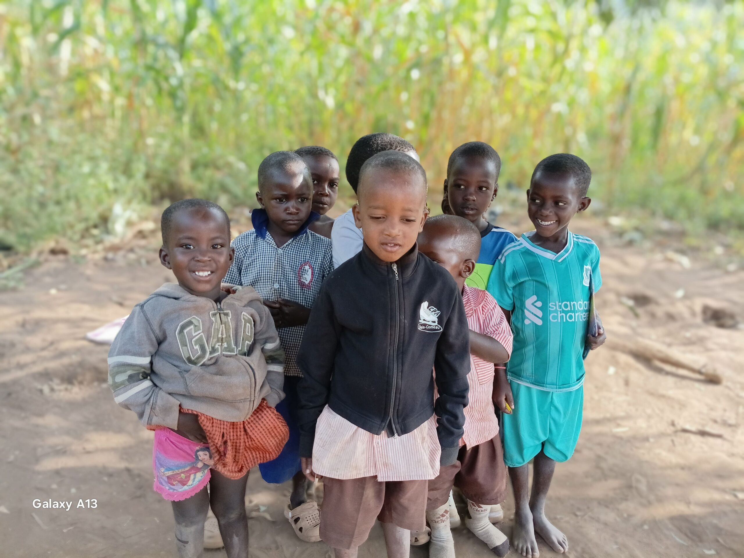 Children standing together in their community in Kifumbira, Uganda